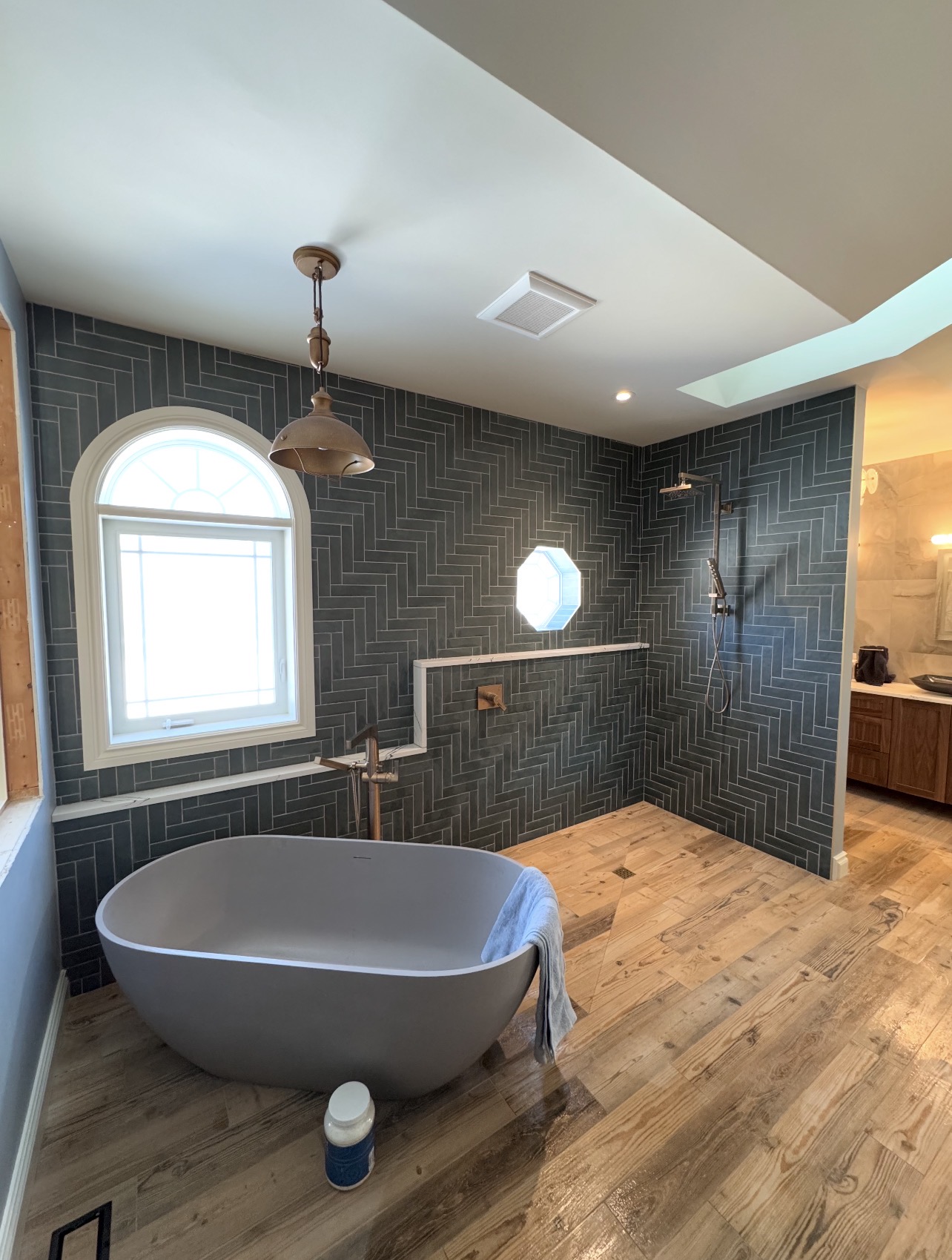 Luxury primary bathroom with herringbone tile — Ottawa Bath and Tile project